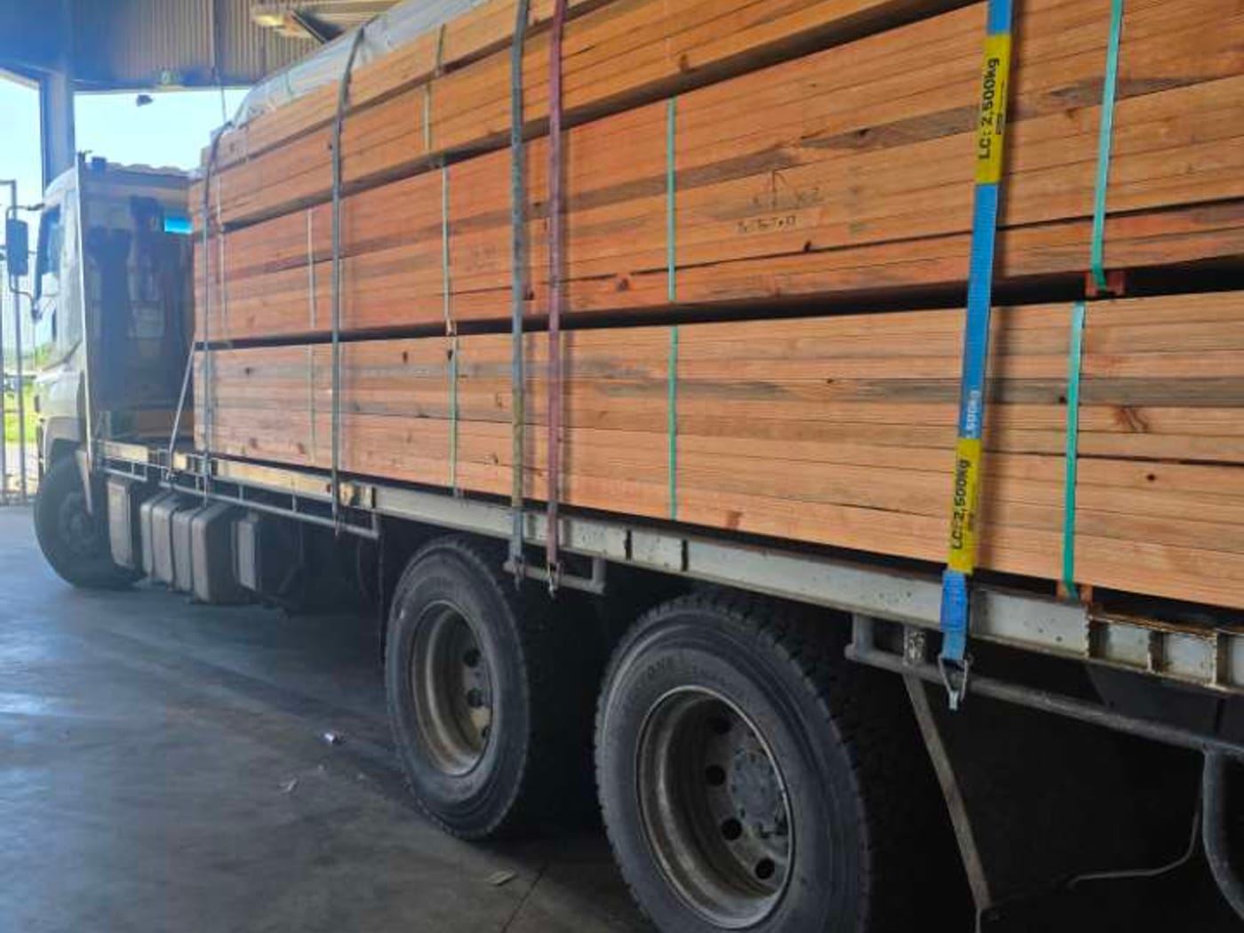 JMG Transport truck loaded with timber inside a Mackay yard