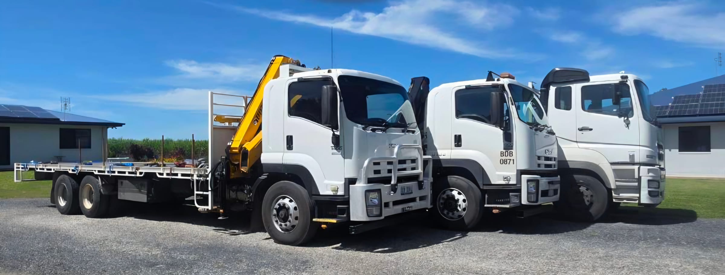 JMG Transport's three crane trucks lined up side-on at the Pleystowe yard near Mackay
